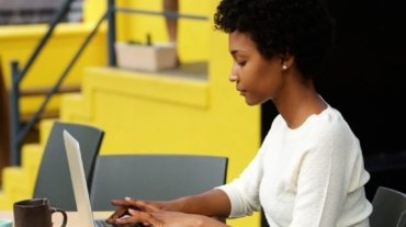 attractive-young-woman-using-laptop-outside-P9RLFGU@2x-1024x798